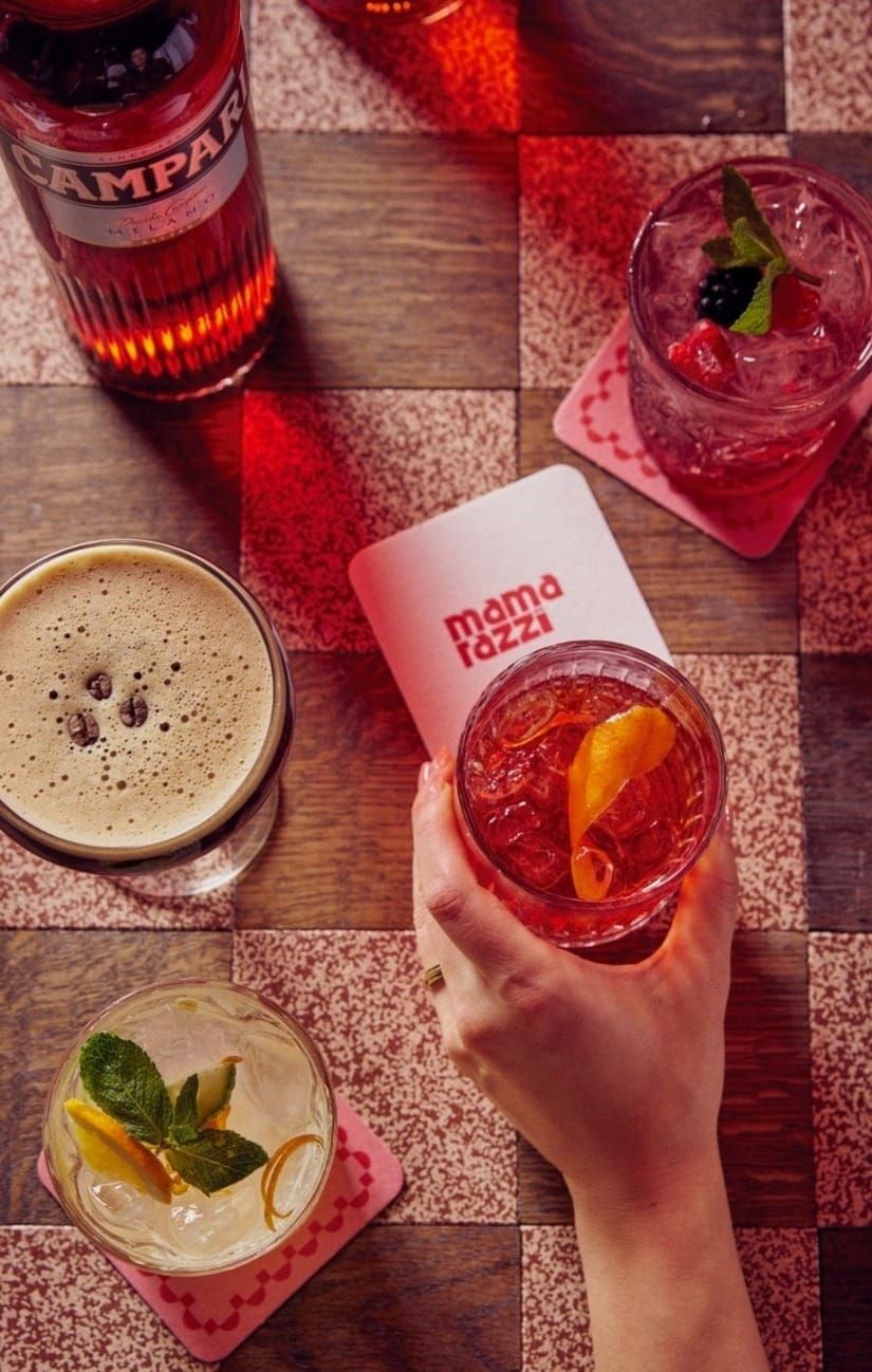 Cocktails and a branded coaster on the checkerboard table top at Mamarazzi